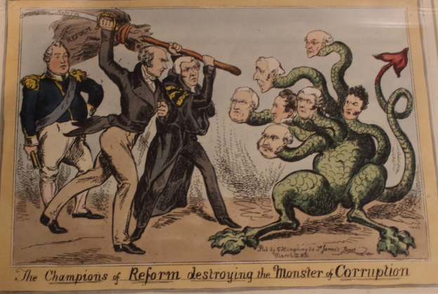 Eine Karikatur auf einem Blatt Papier, die Reformchampions zeigt, die ein Monster namens "Korruption" besiegen, mit dem Text "Die Reformchampions zerstören das Monster der Korruption."