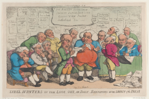 Eine Gruppe von Menschen, die um einen Tisch sitzen und Papiere und Gegenstände haben, einer hölt ein Papier, mit dem Text 'Libel Hunters on the Look Out, or Daily Examiners of the Liberty of the Press' unten.