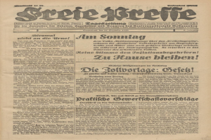 Schwarze und weiße Titelseite einer alten deutschen Zeitung mit einem ernst dreinblickenden Mann, der direkt in die Kamera schaut.